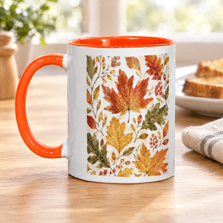 11oz orange inner and handle mug x36 (unboxed) printed with autumn leaves, on a wooden kitchen table