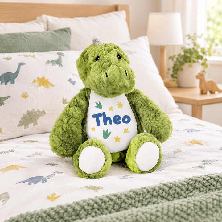 Sublimation light green dinosaur plush toy printed with dinosaur footprints and stars and the name Theo, on a child&