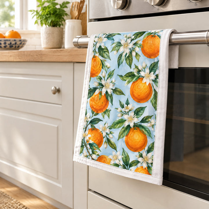 Sublimation tea towels, large, printed with oranges, hanging from an oven door