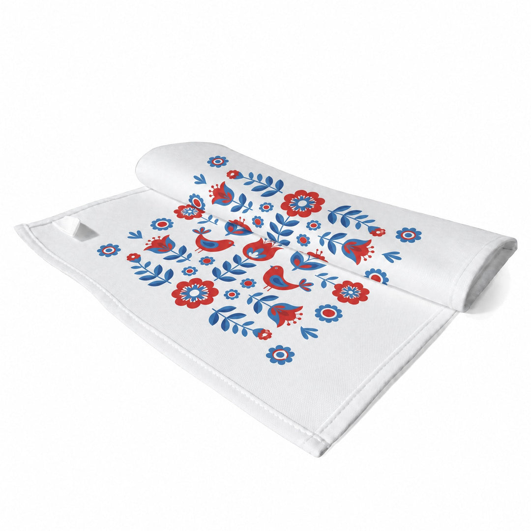 Sublimation tea towels, small, printed with red and blue folk-art flowers and birds, shown folded
