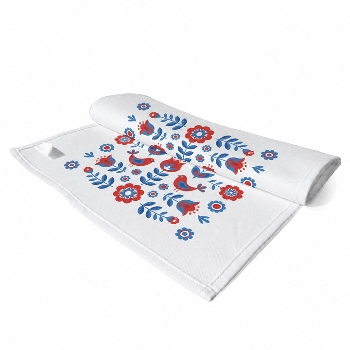 Sublimation tea towels, small, printed with red and blue folk-art flowers and birds, shown folded